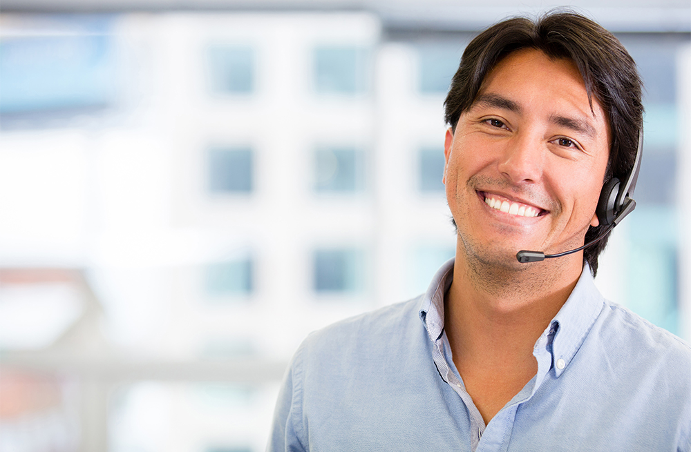 Uśmiechnięty sprzedawca w słuchawkach odpowiada na pytania dotyczące aplikacji CGM Eversense.